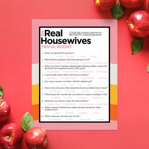 May include: A printable trivia game with a pink and yellow background. The game is about the Real Housewives of New York City. The questions are about the show's history, cast members, and events.