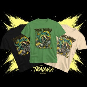 May include: Three t-shirts in black, green, and beige, each featuring a dinosaur graphic with the text "TARGET ACQUIRED." The shirts also display the text "TRAUMA CULTURE" in a stylized font. The background has yellow paint strokes.