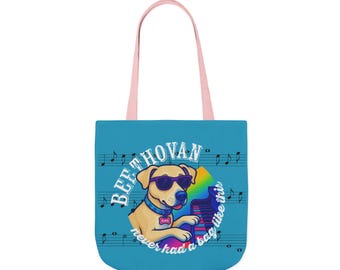 Könnte beinhalten: Eine blaue Tragetasche mit rosa Griffen. Sie zeigt einen Cartoon-Hund mit Sonnenbrille, der ein Regenbogen-Klavier spielt. Der Text lautet "Beethovan never had a bag like this."