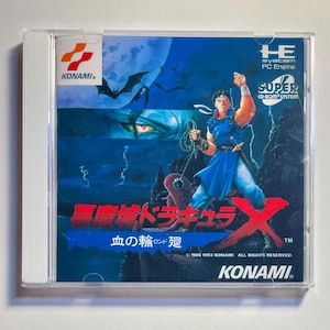 May include: A Super CD-ROM System game case for Akumajo Dracula X: Chi no Rondo, featuring a warrior with a whip, bats, and a castle under a full moon. The Konami logo is visible.