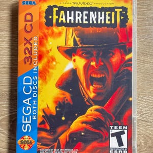 May include: A SEGA CD game case for Fahrenheit. The cover art features a man in a hat with an open mouth, set against a fiery background. The case includes the SEGA logo and text indicating it's a 32X CD with both discs included.