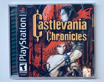 May include: Castlevania Chronicles PlayStation game in a clear plastic case. The cover art features a gothic illustration with a red and gold color scheme, and the game title is prominently displayed.