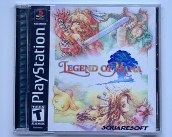 May include: A PlayStation game case with a white background and colorful artwork. The game is called "Legend of Mana" and features a group of characters in a fantasy setting. The game is rated "Teen" by the ESRB.
