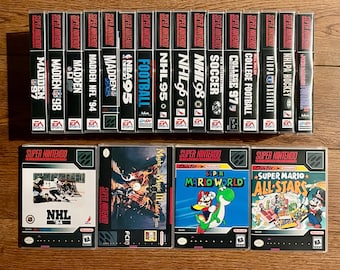 May include: A collection of Super Nintendo video game cases, including fifteen vertical spines labeled Madden, NBA, NHL, FIFA, and College Football, alongside four front-facing game boxes: NHL '94, Might and Magic III, Super Mario World, and Super Mario All-Stars.