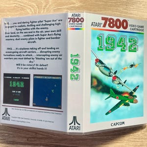 May include: An Atari 7800 video game cartridge for the game "1942." The box art features a blue sky background with green and red fighter planes in flight. The game title is in large green numbers.