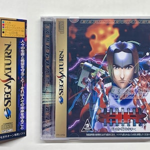 May include: A Sega Saturn video game case with a blue and gold design. The game is called "Burning Rangers" and features a group of characters in a futuristic setting. The text on the case reads "SEGA SATURN" and "Burning Rangers".
