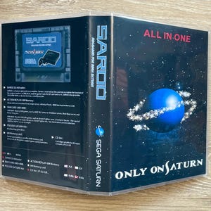 May include: A clear plastic game case for the SAROO SS Hdloader for Sega Saturn. The cover features a blue planet with rings against a starry background, the text ALL IN ONE, and ONLY ON SATURN. The back displays technical specifications and features.