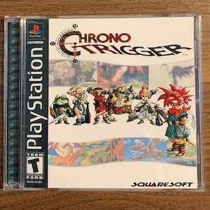 May include: Chrono Trigger PlayStation game case. The cover features a group of illustrated characters with a red-haired protagonist. The game title is in a stylized font. The case is in a clear plastic case with the PlayStation logo.