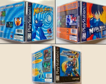May include: Four PlayStation video game cases featuring Mega Man. The first case is blue and features Mega Man 8, the second case is orange and features Mega Man Legends, the third case is blue and features Mega Man X4, and the fourth case is blue and features Mega Man Legends.