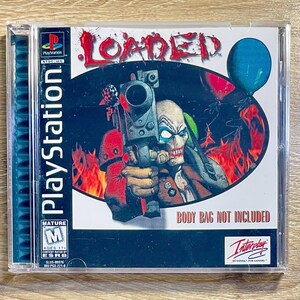 May include: A PlayStation game case for "Loaded." The cover art features a menacing clown holding a large gun, set against a backdrop of flames and a blue balloon. The game's title is in red, with the text "BODY BAG NOT INCLUDED."
