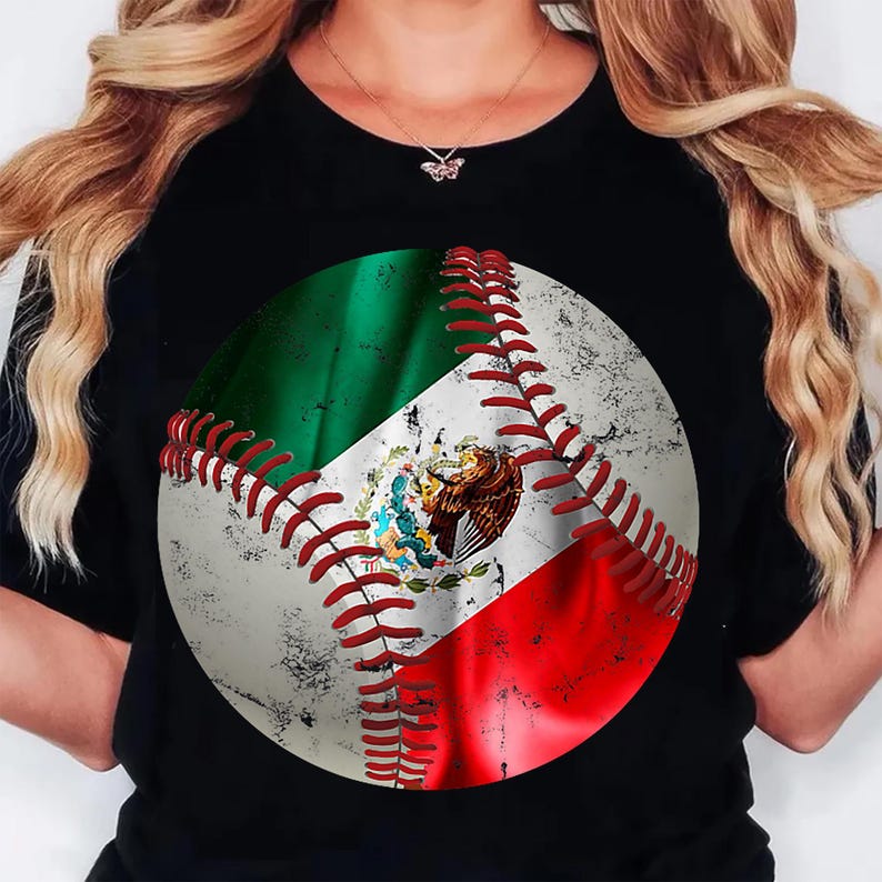May include: Black t-shirt with a baseball design incorporating the Mexican flag. The baseball has red stitching and a distressed, vintage appearance. The flag's green, white, and red colours are prominent, with the Mexican coat of arms in the centre.