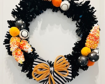 Halloween wreath with candy corn and a bow