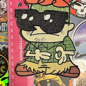 May include: A weathered wooden sign, inscribed with "Welcome to our porch" in white. The sign has a distressed appearance, ideal for adding a touch of rustic charm to a porch or garden.