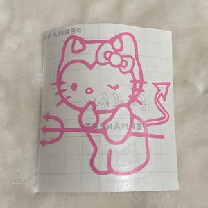 May include: Pink vinyl decal featuring a cartoon cat with devil horns, a tail, and a trident. The cat has a bow and is winking. The decal has the word "PERMANENT" in reverse at the top and other text.