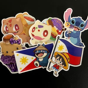 May include: A collection of colorful stickers featuring cartoon characters like Bulbasaur, Stitch, and Hello Kitty. The stickers also include images of the Philippine flag and a character from One Piece. The stickers are on a black background.