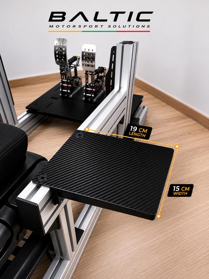 May include: A black carbon fiber textured side tray mounted on a silver aluminum racing simulator rig. The tray measures 19 cm in length and 15 cm in width. The text BALTIC MOTORSPORT SOLUTIONS is visible at the top of the frame.