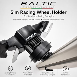 May include: A black Fanatec sim racing wheel holder by Baltic Motorsport Solutions. The text reads: Sim Racing Wheel Holder, For Simulator Racing Cockpits, One-Piece Design, Secure Fitment, Mounting Hardware Included, Strong & Stable Connection, Quick & Easy Installation, Compatible with Sim Racing Cockpits, Built for Performance.