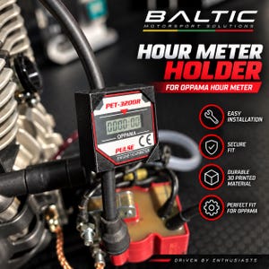 May include: A black hour meter holder for an Oppama PET-3200R engine hour meter. The device features a digital display showing 0000:00, with text reading PULSE and CE. The holder is mounted near engine components, including a red ignition coil unit.