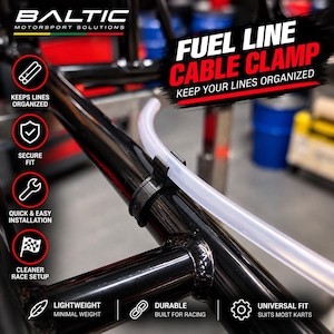 May include: A black plastic fuel line cable clamp attached to a black metal frame, holding a clear flexible tube. The image features text including BALTIC MOTORSPORT SOLUTIONS, FUEL LINE CABLE CLAMP, and various icons with labels like SECURE FIT.
