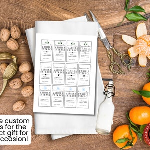 May include: Printable labels for vanilla extract bottles. The labels feature a simple design with a heart and a small tree graphic. The text on the labels reads "Homemade Vanilla Extract with Love".
