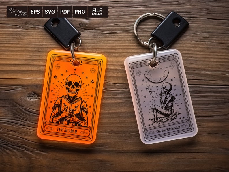 May include: Two keychains with a skeleton design. The keychain on the left is orange and features a skeleton reading a book with the text "The Reader". The keychain on the right is white and features a skeleton sitting with the text "The Overthinker".