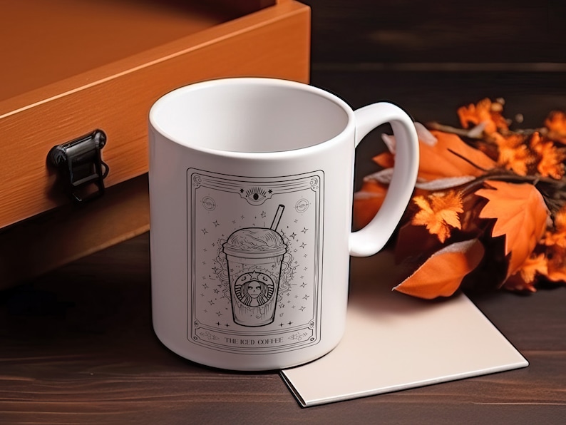 May include: White ceramic mug with a black and white illustration of an iced coffee drink with the text "The Iced Coffee" on the front.