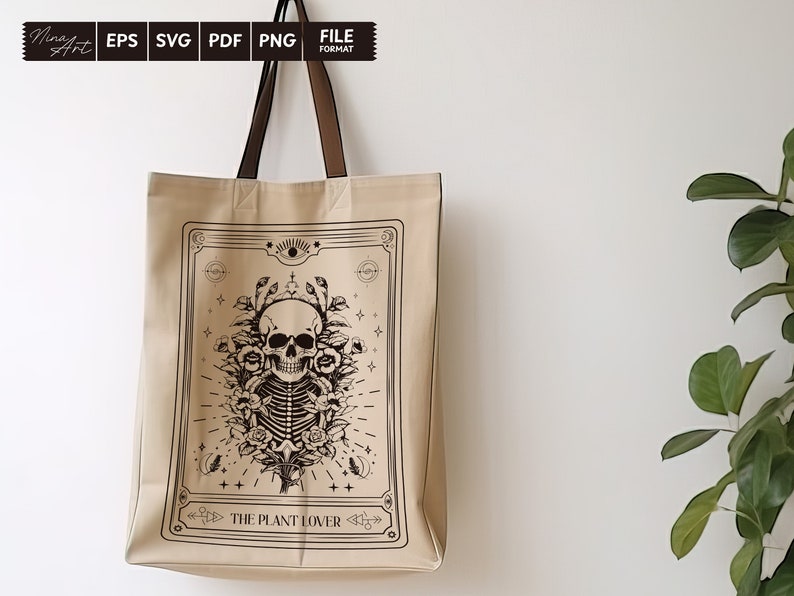 May include: A beige tote bag with a black and white illustration of a skull with flowers and the text "The Plant Lover".