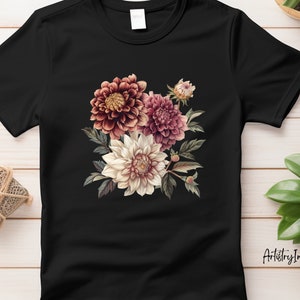 Pu&ograve; includere: Maglietta nera con un design floreale con dalie rosa, bianche e marroni. Il design &egrave; centrato sulla maglietta e ha un'estetica vintage.