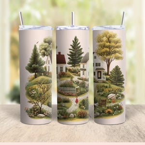 Puede incluir: Tres vasos de acero inoxidable con fondo blanco y una ilustraci&oacute;n colorida de un camino sinuoso a trav&eacute;s de un peque&ntilde;o pueblo con casas y &aacute;rboles.
