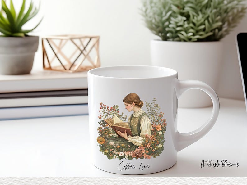 Puede incluir: Taza de caf&eacute; de cer&aacute;mica blanca con un dise&ntilde;o floral y una mujer leyendo un libro. La taza tiene el texto "Coffee Lover" en la parte inferior.