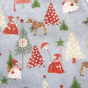 May include: A blue fabric with a repeating pattern of Christmas trees, deer, and people wearing red hats and coats. The trees are decorated with red and white polka dots, snowflakes, and stars. The fabric is perfect for crafting projects like quilts, pillows, and bags.