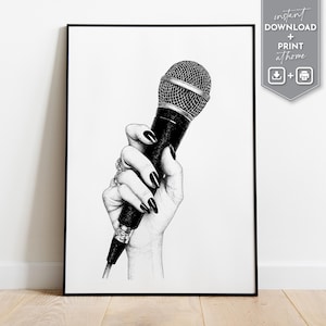 May include: Black and white illustration of a hand holding a microphone. The hand has long, black fingernails and is adorned with rings. The microphone is black with a silver mesh head. The artwork is framed in a black border.