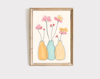 Op de afbeelding: Een ingelijst afdruk van een lijnkunst-illustratie van drie vazen met roze en gele bloemen. De vazen zijn geel, blauw en groen.
