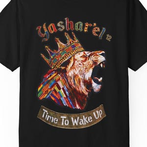 May include: Black t-shirt featuring a colorful lion wearing a crown, with the text "Yasharel 12" above and "Time To Wake Up" below. The lion graphic is vibrant, with a mix of colors. The shirt is a classic crew neck.