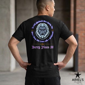 May include: Black t-shirt with a circular graphic of a yeti face and text that reads "Ice Cold Adjustments Since Opening Day" and "Where Every Ride Comes with a Realignment." Below the graphic is the text "Berry Place 28."