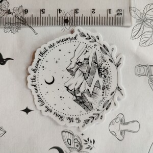 May include: Black and white sticker with a mountain range, crescent moon, and stars. The text reads "To the Stars who listen and the dreams that are answered".