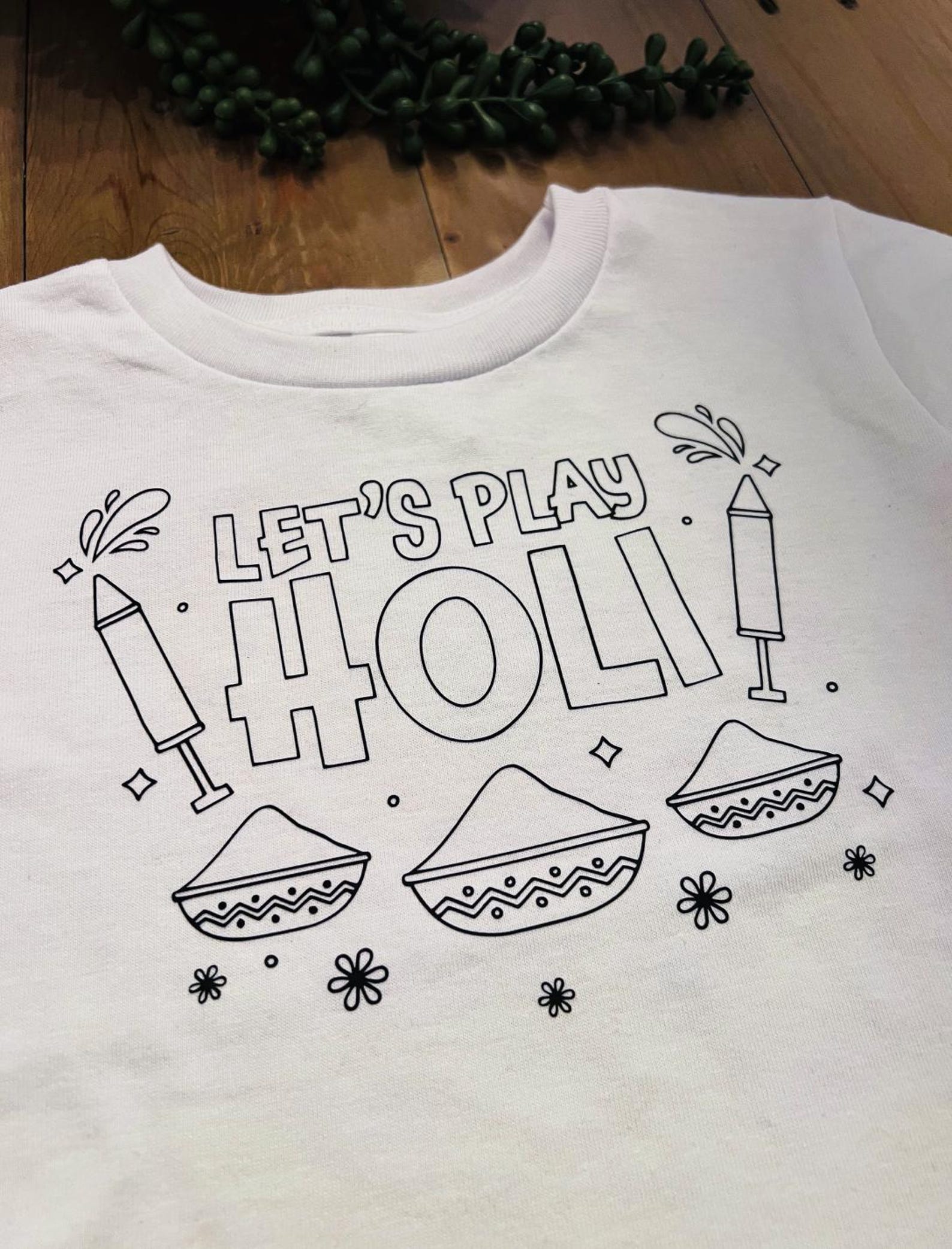 A white T-shirt with black graphics on it