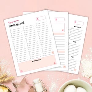 May include: Three white paper grocery list notepads with pink accents. The top notepad reads "Grocery List" in a handwritten font. Each notepad has a section for notes and reminders, and a section for items to buy.