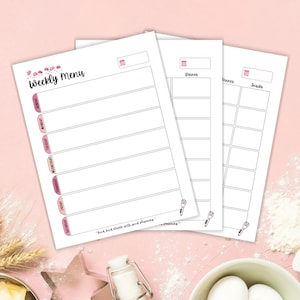 May include: A stack of three white weekly menu planner sheets with pink accents. The top sheet reads "Weekly Menu" with days of the week listed in pink. The other sheets are for dinner and snacks. A quote at the bottom reads "Good food starts with good planning."