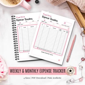 May include: Two pink and white expense trackers with a spiral binding and a pen. The trackers have a pink border and the words "Expense Tracker" at the top. The text "Weekly & Monthly Expense Tracker" is at the bottom.