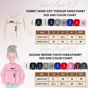May include: Size and color chart for Rabbit Skins 3317 toddler sweatshirts and Gildan 18000B youth sweatshirts. The chart shows measurements in inches for width and length, along with color options including white, black, and navy.