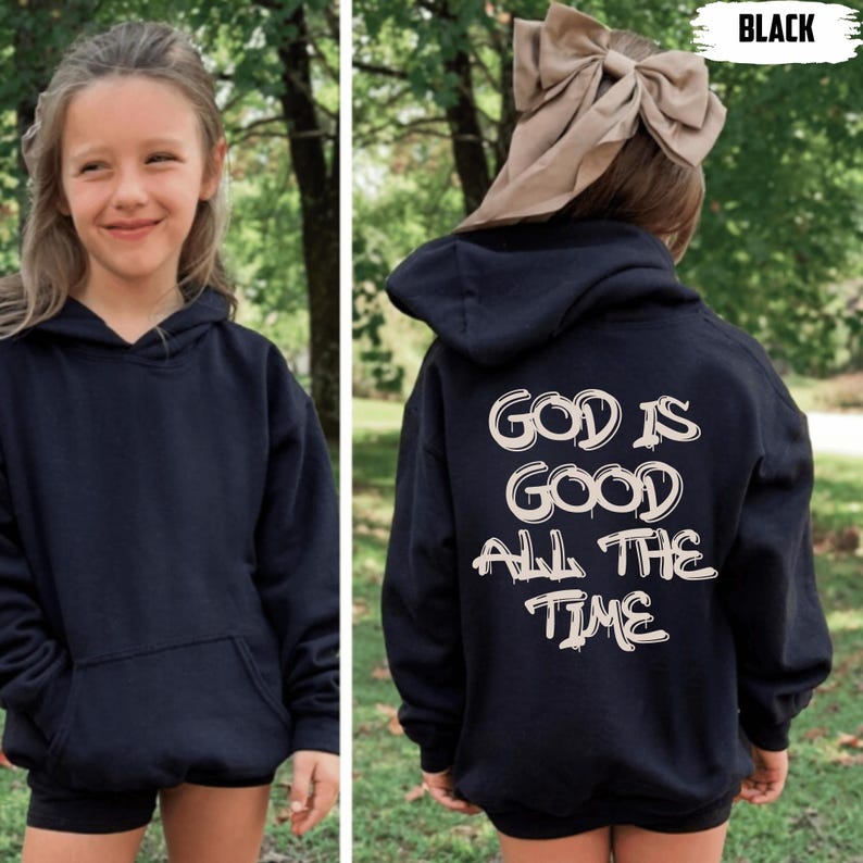 May include: Black hoodie with the text "GOD IS GOOD ALL THE TIME" in white. The hoodie has a front pocket and a hood. The image shows a young person wearing the hoodie. The word "BLACK" is in the top right corner.