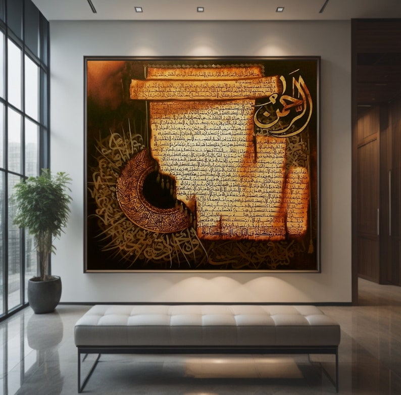 May include: A large framed artwork with gold Arabic calligraphy on a textured, aged paper background. The artwork features detailed script and a crescent moon design, creating a rich, cultural aesthetic. The piece is displayed in a modern interior setting.