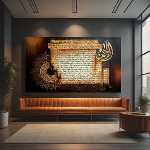 May include: A large rectangular artwork with gold Arabic calligraphy on a dark backdrop. The artwork has a vintage, aged paper appearance with intricate patterns and text. It hangs above a brown leather sofa in a modern living room setting.