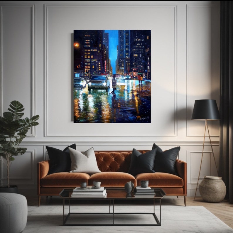 May include: A painting of a city street at night with cars driving down the street and people walking on the sidewalk. The street is wet from rain and the reflections of the streetlights are visible in the puddles. The buildings on either side of the street are tall and have many windows. The painting is done in a realistic style and has a warm, inviting feel.