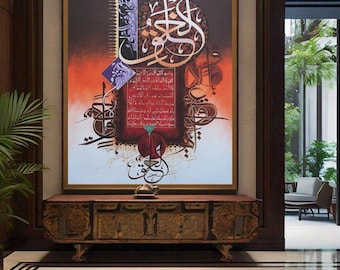 May include: A framed artwork featuring intricate Arabic calligraphy in black, gold, and blue on a red and white background. The calligraphy is surrounded by a decorative border and includes a small rectangular section with additional text.