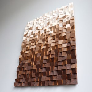May include: A wall art piece made of wood with a gradient of brown shades, from light to dark, creating a textured and modern look.