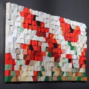 May include: A wall art piece made of wood squares in various shades of red, white, and green. The squares are arranged in a pattern that resembles flowers.