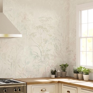 May include: A kitchen wall covered in wallpaper featuring a delicate, light-toned botanical print of wildflowers and grasses in soft shades of beige, white, and pale green, positioned above a wooden countertop with several small potted plants.