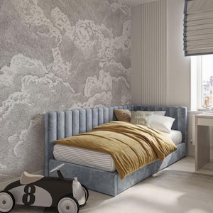 May include: A light blue upholstered bed with a tufted headboard and a yellow blanket. The bed is in a bedroom with a white wall and a gray and white patterned wallpaper. The text "Happy Life" is on a pillow on the bed.